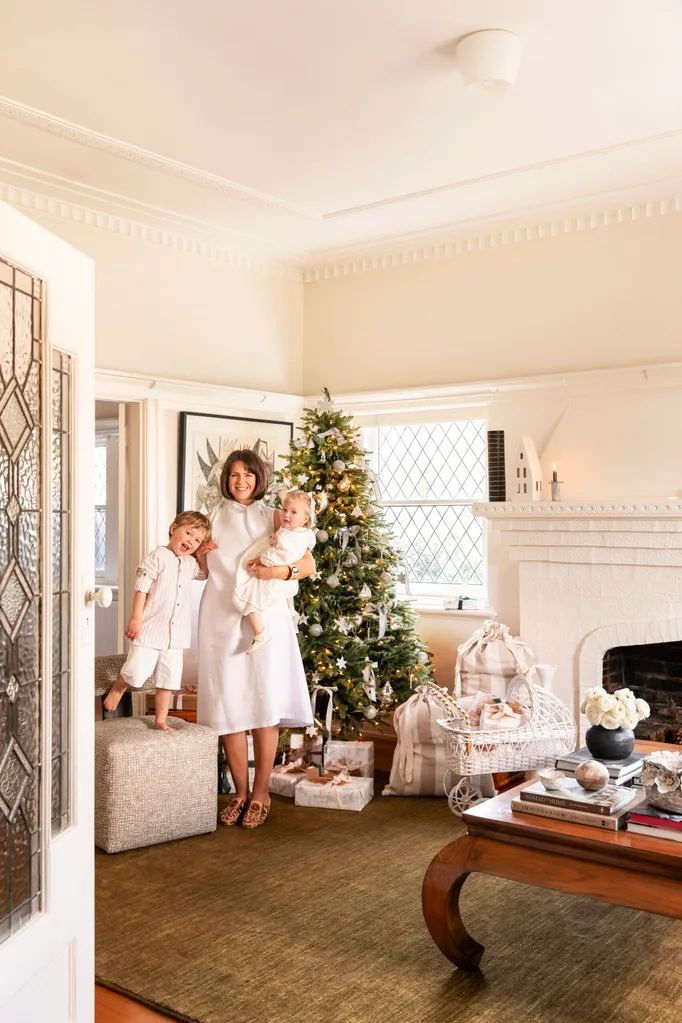 Katie Sargent with her children in front of the Christmas tree.
