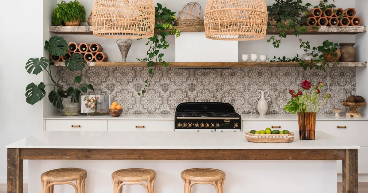Kitchen with white walls, white joinery, reclaimed timber open shelving and patterned tile splashback.