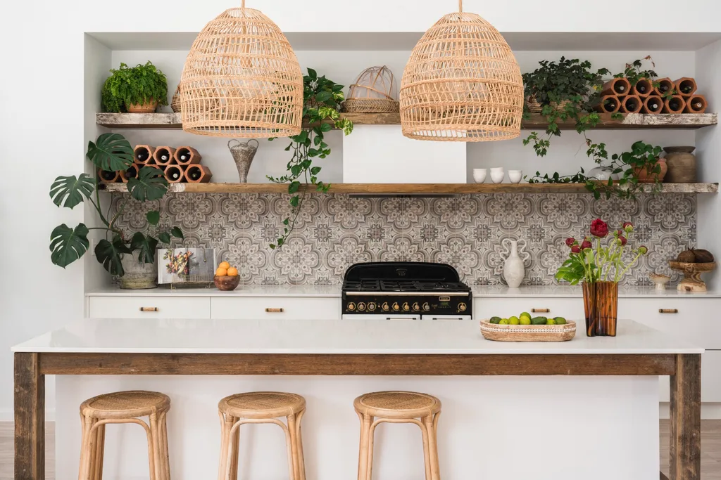 Kitchen with white walls, white joinery, reclaimed timber open shelving and patterned tile splashback.