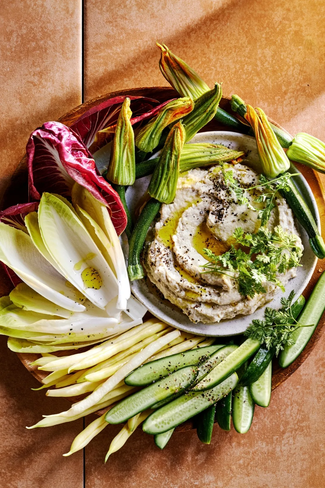 Whipped baba ganoush with Italian-style cruidtes including endives, zucchini flowers, radicchio Treviso and baby cucumbers
