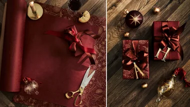 red christmas wrapping papaer flatlay with vintage scissors and brass candlestick