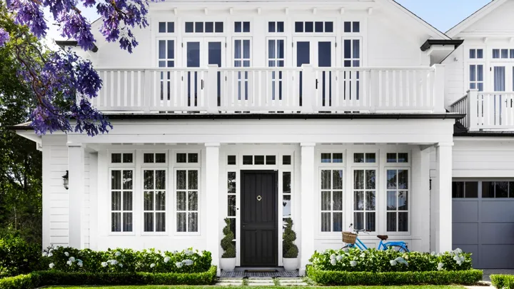 The facade of a white Cape Cod style home on Sydney's lower north shore.