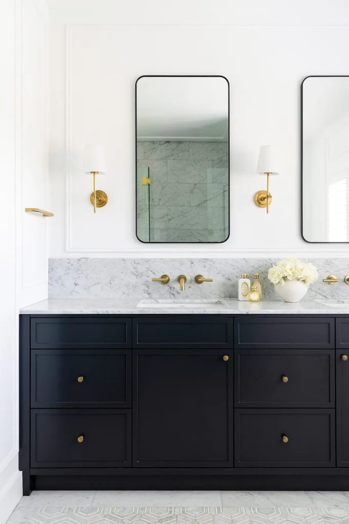 A Cape Cod style bathroom with dark cabinetry.