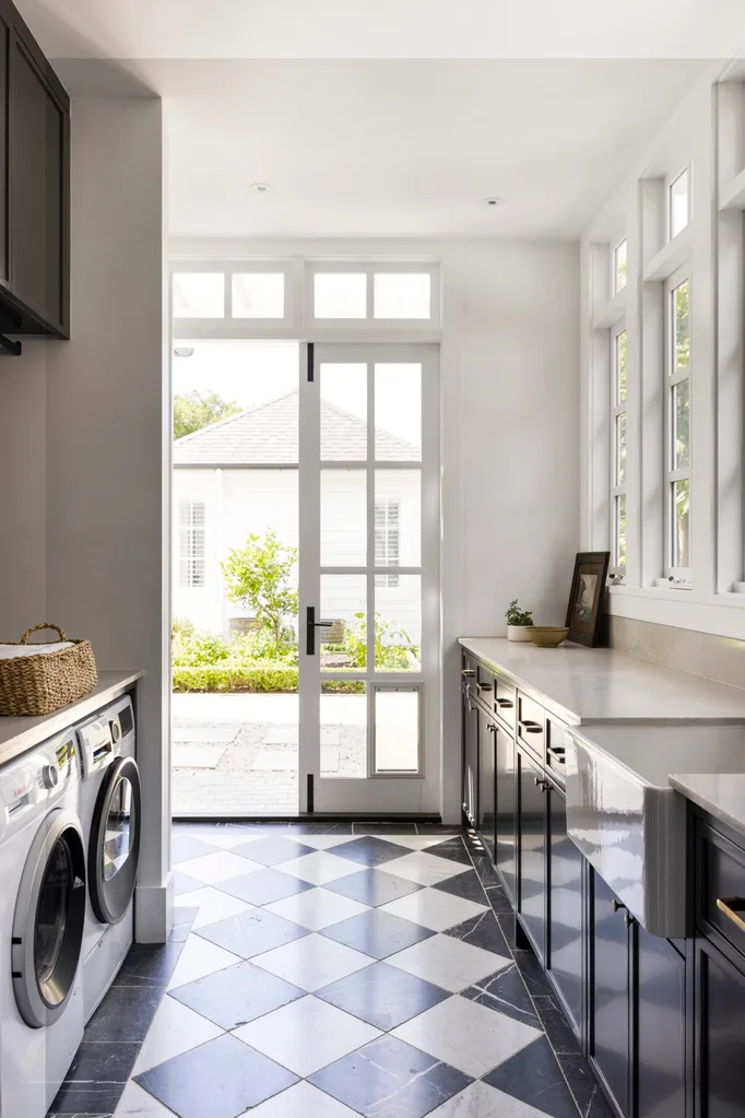 A laundry with checkerboard flooring.
