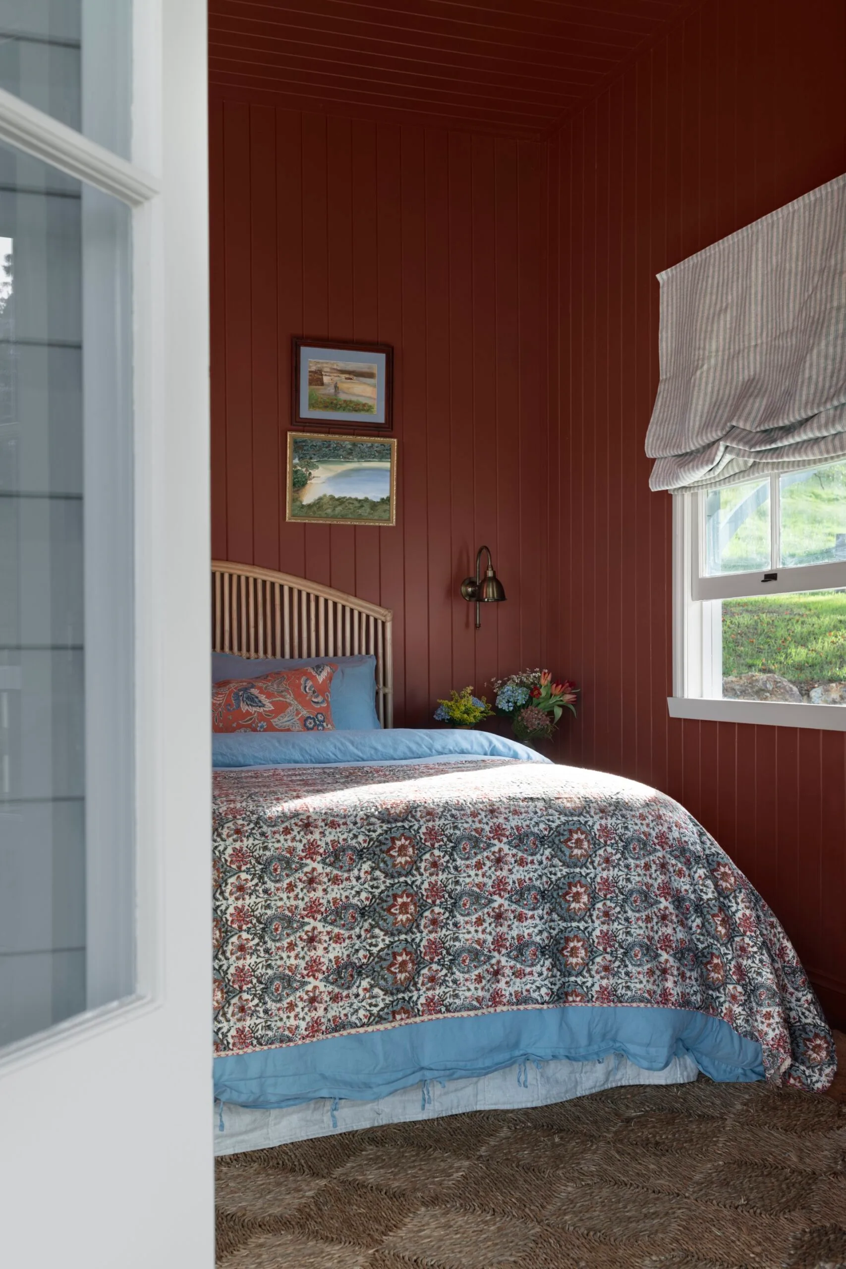 The red bedroom inside a century-old cottage renovation. 
