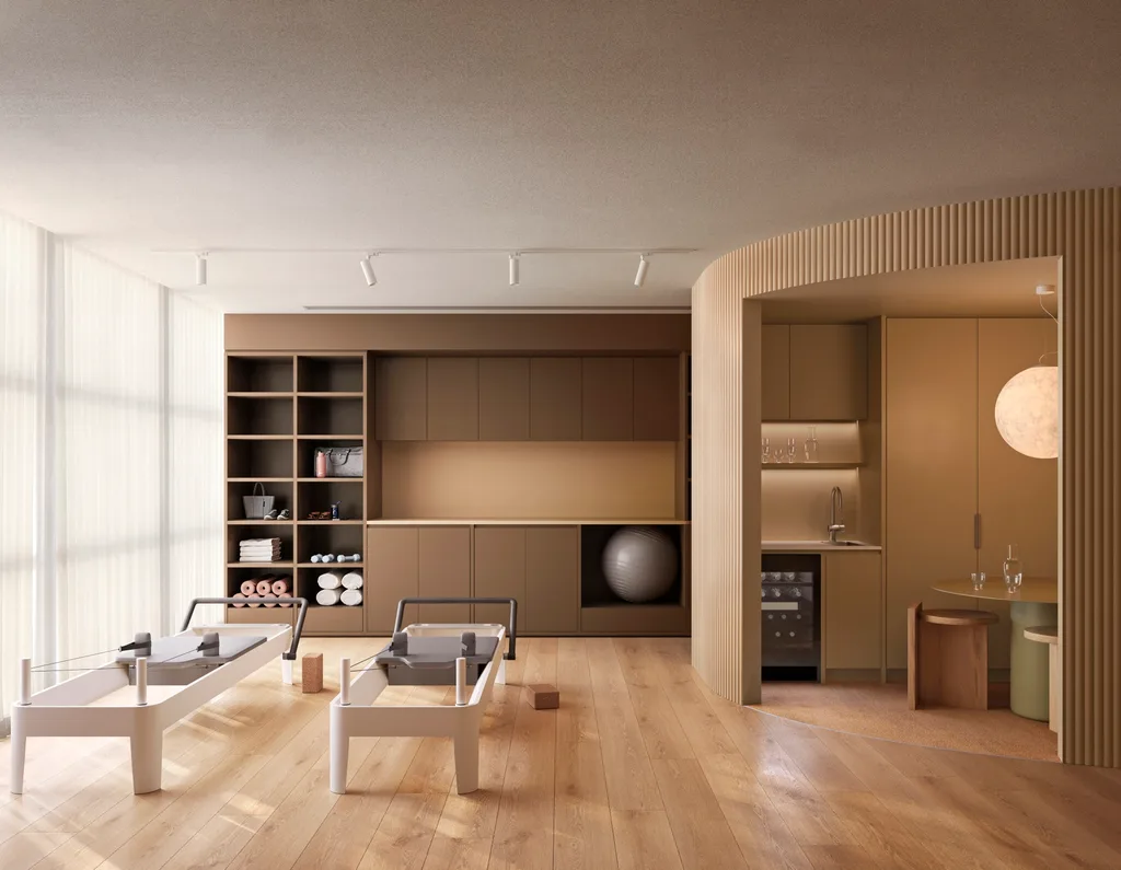 A warm toned pilates studio with two reformer pilates machines.