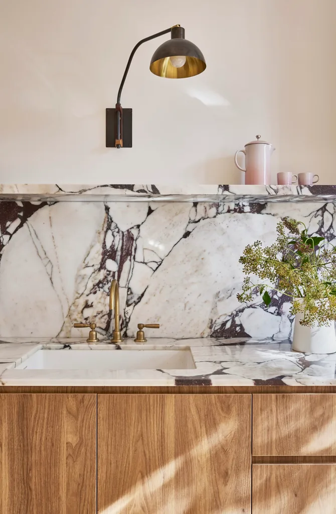 Timber underbench joinery with calacatta viola marble forming the benchtop and splashback. The kitchen set is in Rumbled Brass Organic.