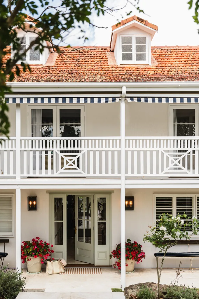 White facade with two storeys and terracotta tile roof