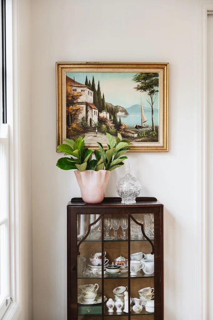 Vignette with artwork and pot on cabinet