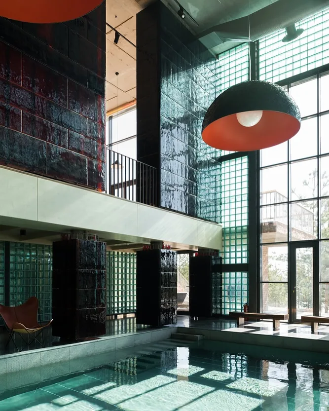 Non-standard hotel glass blocks wall beside pool