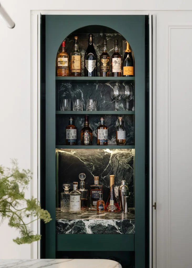 Hidden bar with green and marble accents