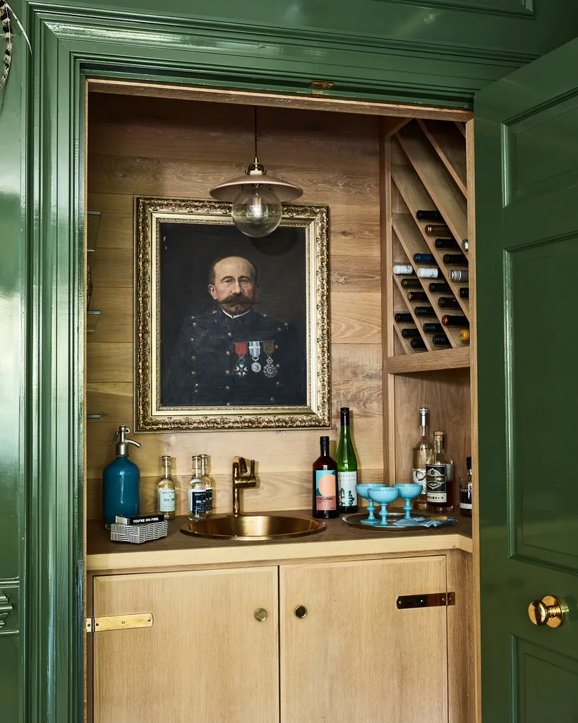 High gloss green cabinetry around bar