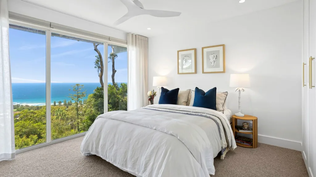 Mitch and mark from the block's newport house for sale with white hamptons style guest bedroom featuring navy cushions and beige carpet