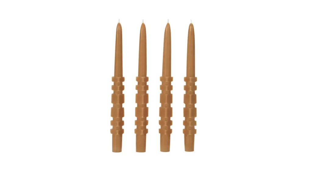 Four caramel-coloured textured candlesticks.