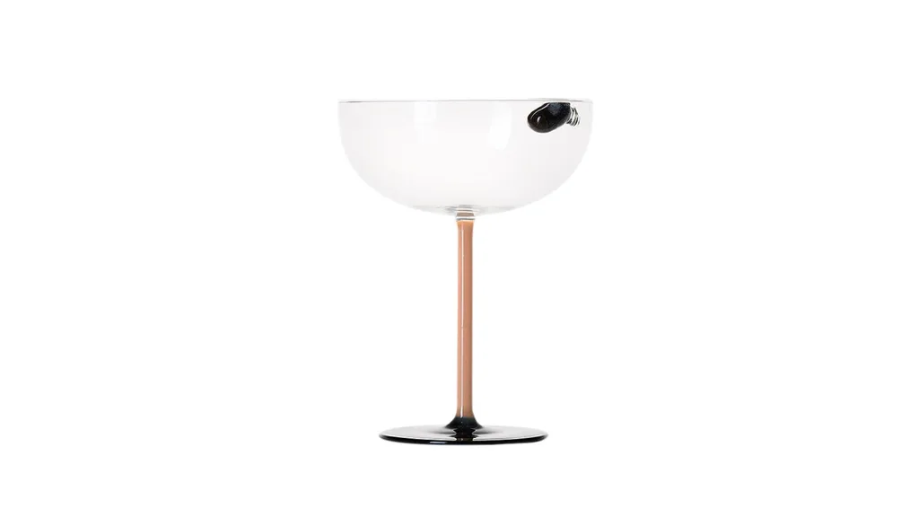 A martini glass with ceramic espresso bean inside the glass for decoration.