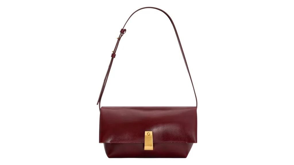 A burgundy clutch bag with removable arm strap and a gold clasp, an option for Mother's Day gifts.