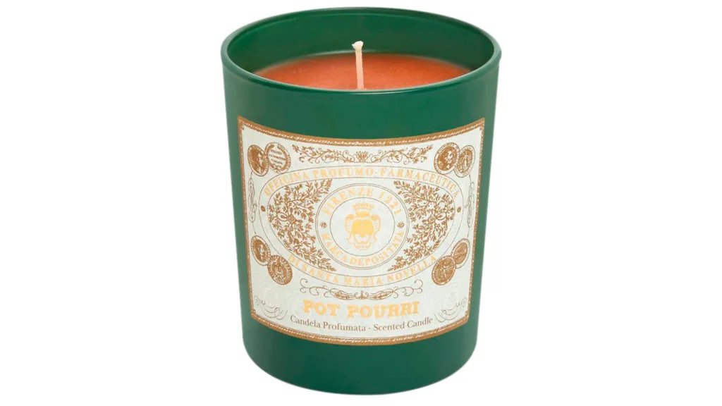 A pot-pourri scented candle in a green case.