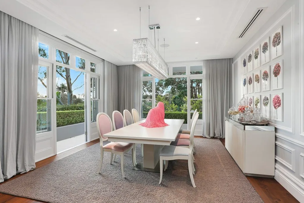 Nicole O'Neil from Real Housewives of Sydney's formal dining room with Swarovski chandelier and pastel coloured chairs.