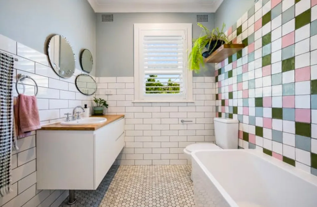 Retro bathroom with white subway tiles, mosaics and penny round tiles with a floating vanity