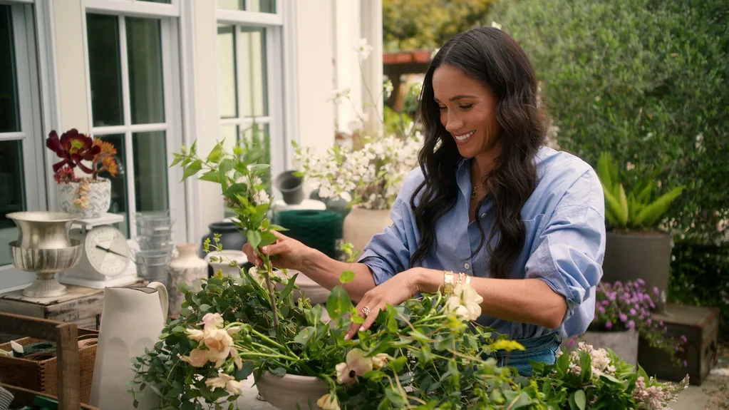 Meghan creating a floral arrangement in a vase
