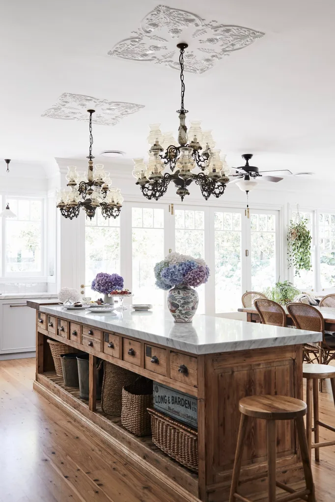 alexandra nea's kitchen vintage oak island bench topped with carrara marble, with chandeliers, hydrangeas and timber bar stools