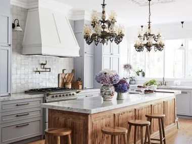 Alexandra Nea's kitchen with chandeliers over bench
