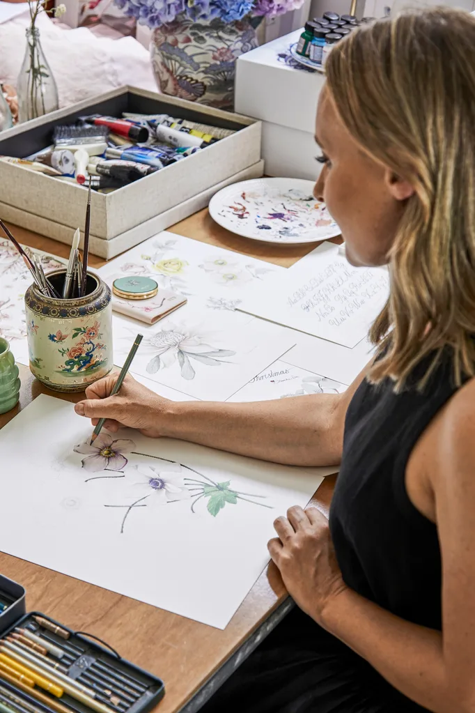 Illustrator Alexandra Nea in her home studio working on a Japanese anemones illustration