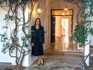 DLeanne Lewis outside a house entry with vines at the door