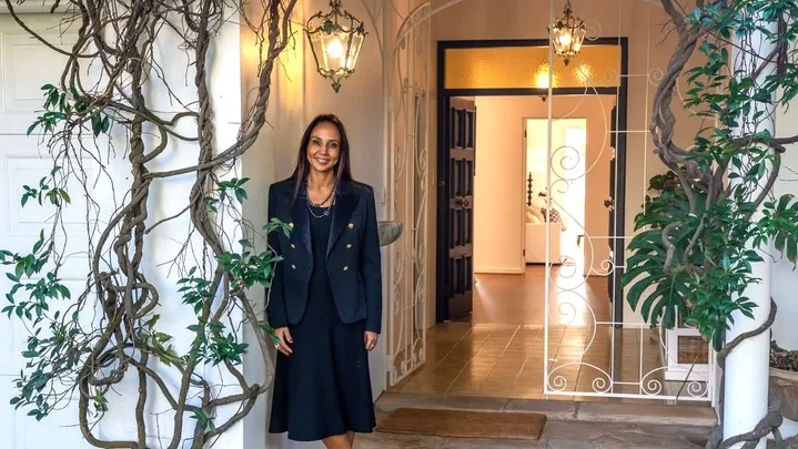 DLeanne Lewis outside a house entry with vines at the door