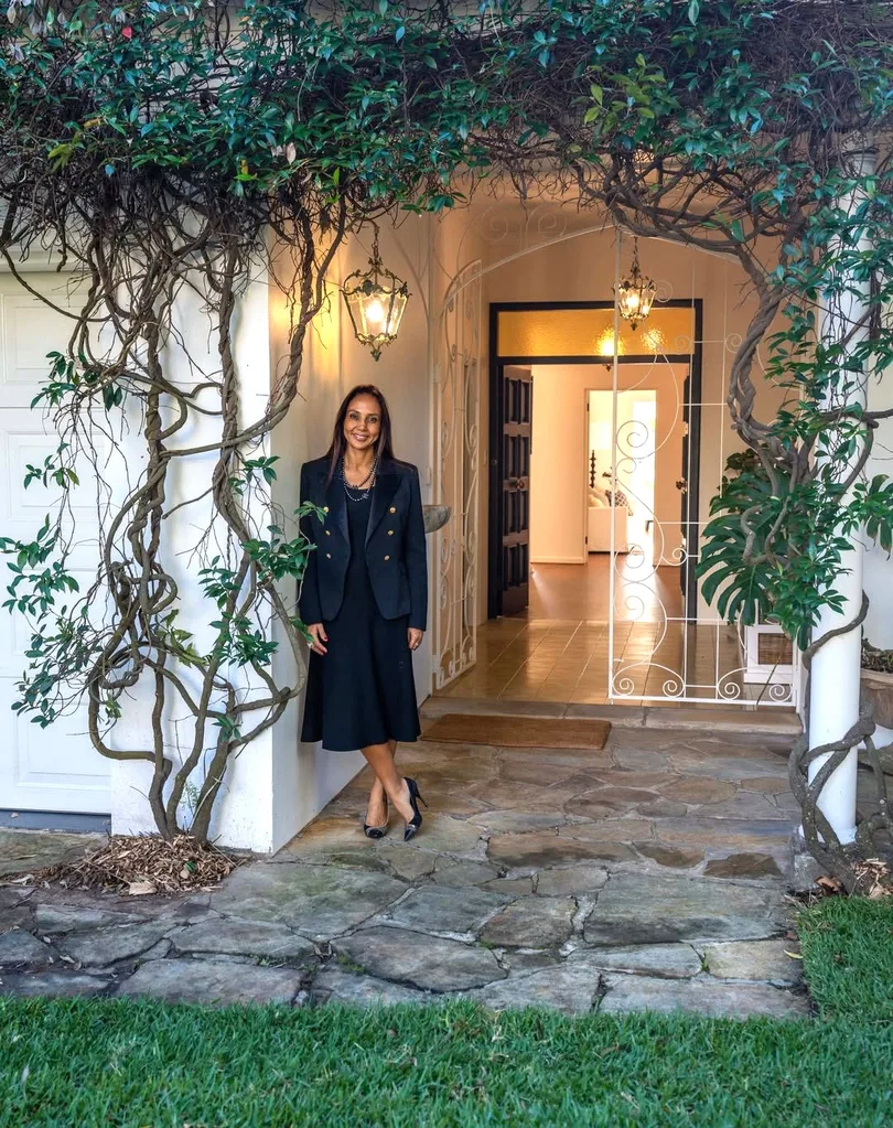 DLeanne Lewis outside a house entry with vines at the door