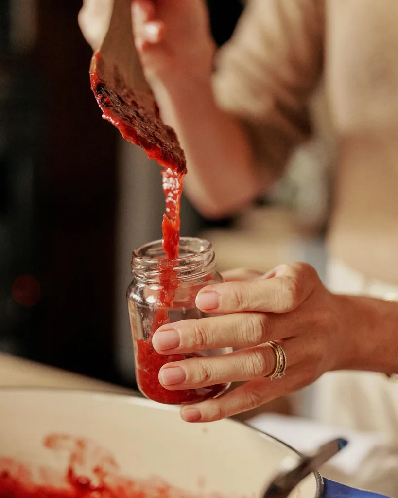 Meghan pouring spread into a jar