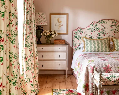 Main bedroom with floral curtains and floral bedhead