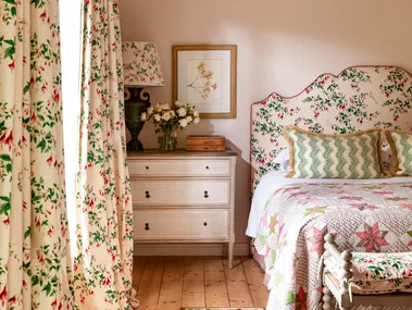 Main bedroom with floral curtains and floral bedhead