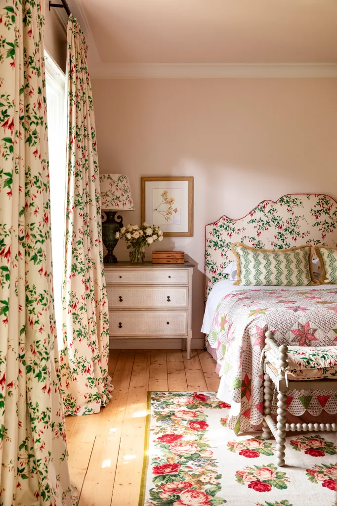 Main bedroom with floral curtains and floral bedhead