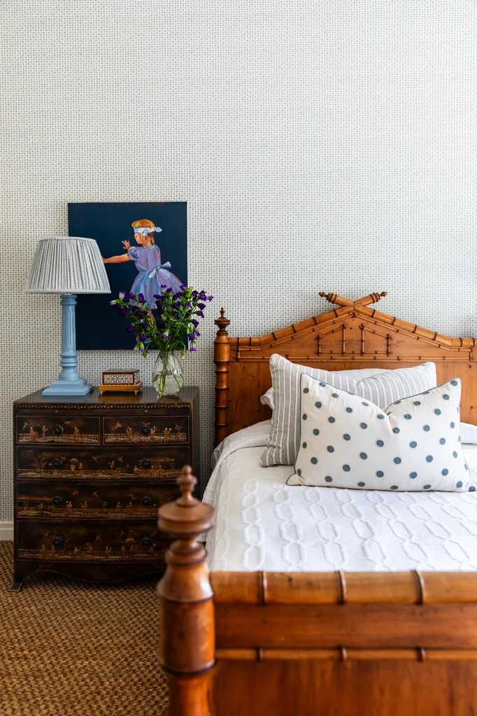 Girl's bedroom with rustic bedhead and side table holding blue lamp