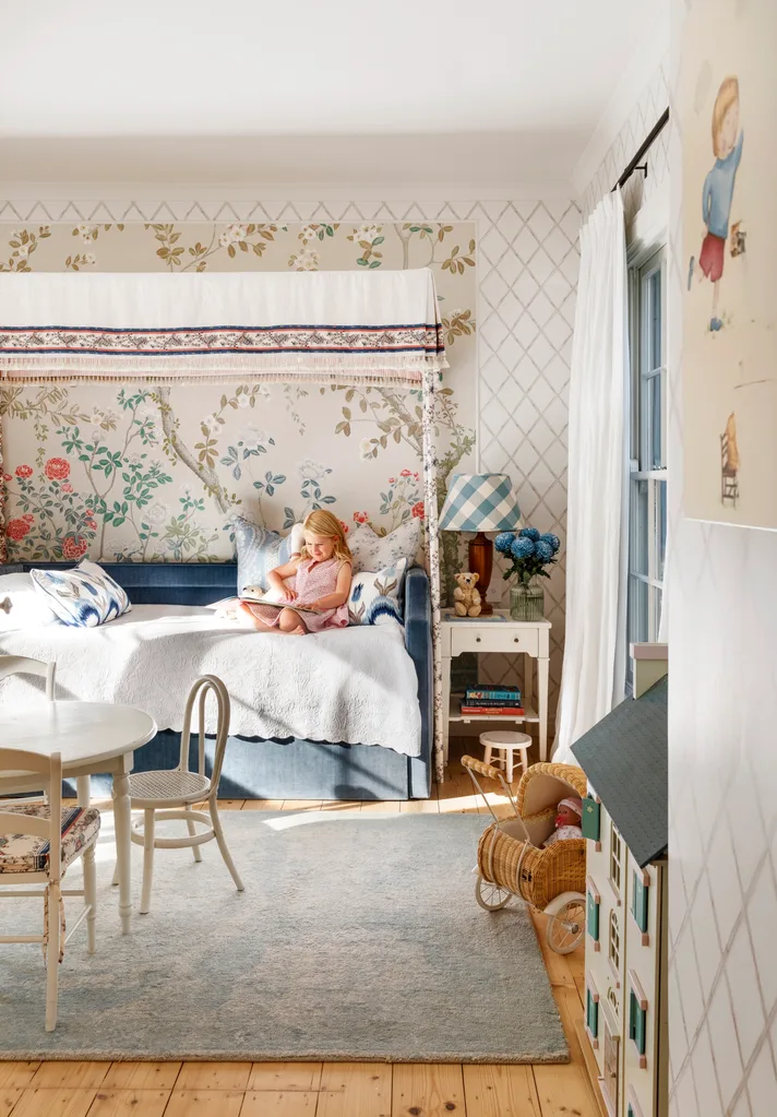 Girls bedroom with child sitting on day bed