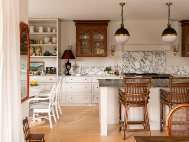 Kitchen with vintage style pendants and marble splashback