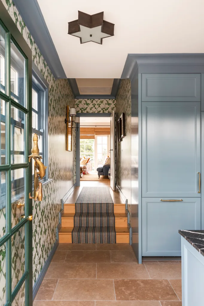 Hallway and stairs next to mudroom and laundry