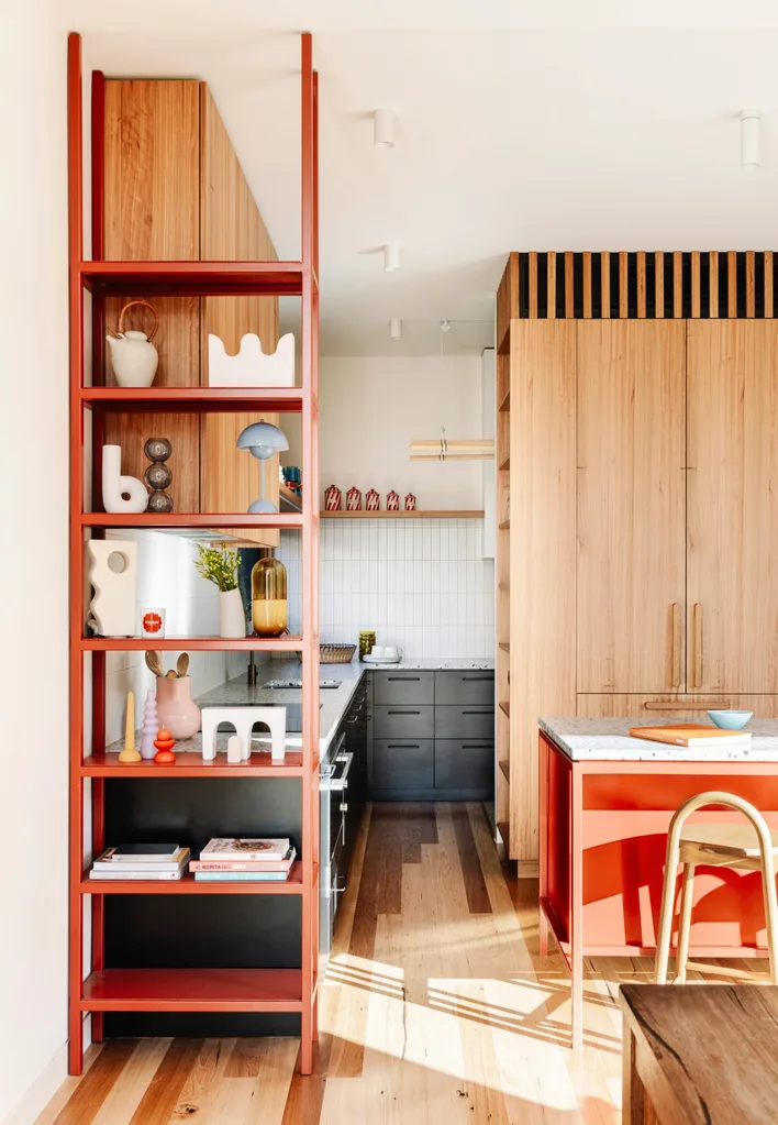Red kitchen shelving in a timber kitchen.