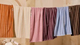 A collection of Hommey Australian bath towls on a drying rack