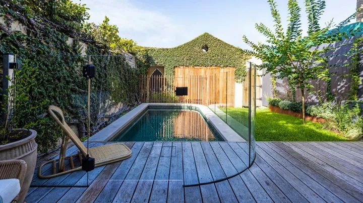 A garden makeover with a pool, deck and lawn.