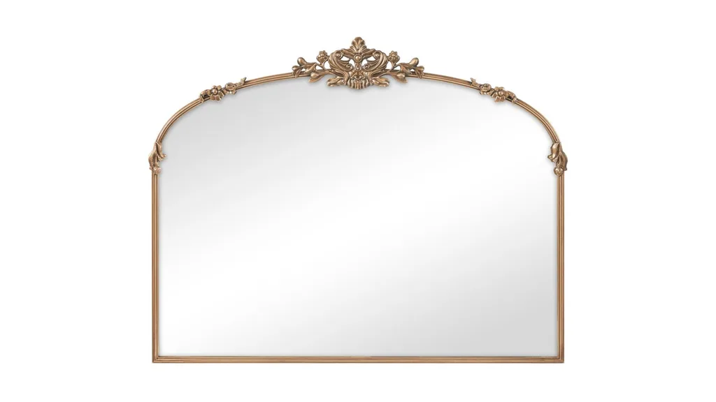 A mirror with a gold frame