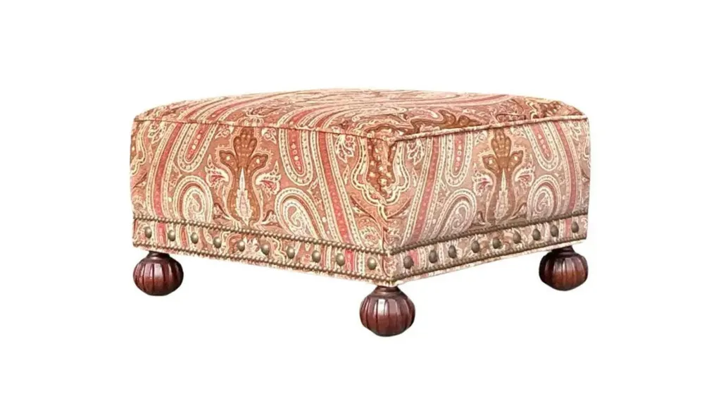 A fabric ottoman with round feet
