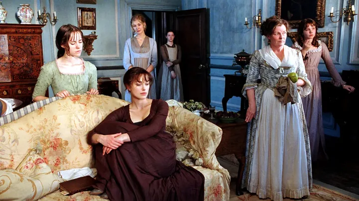 A still from the 2005 Pride and Prejudice movie, with the Bennet sisters and Mrs Bennet in the living room of their home.