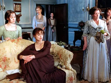 A still from the 2005 Pride and Prejudice movie, with the Bennet sisters and Mrs Bennet in the living room of their home.