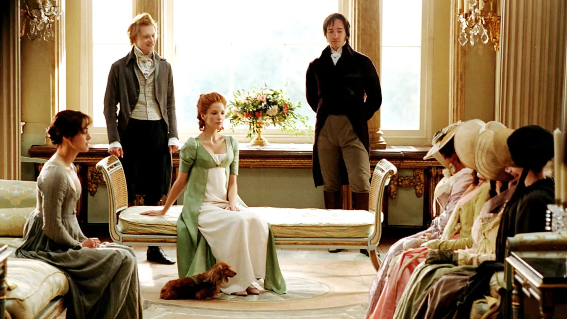 A still from the 2005 Pride and Prejudice movie, with Mr Darcy, Mr Bingley and Caroline Bingley hosting the Bennet sisters and Mrs Bennet at Pemberley.