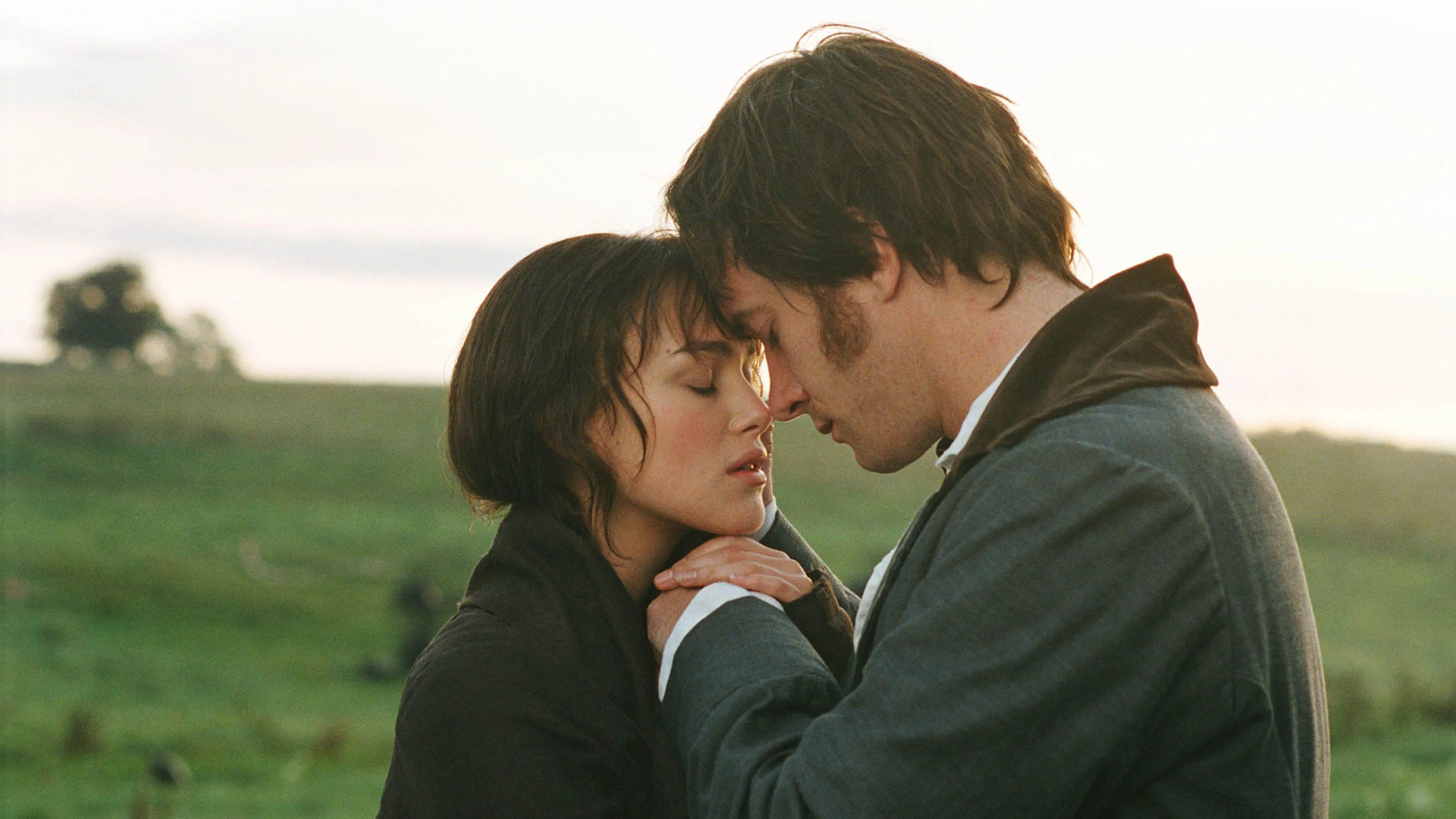 Keira Knightley and Matthew McFayden clasp hands and touch their foreheads together passionately as Lizzie and Darcy in Pride and Prejudice.