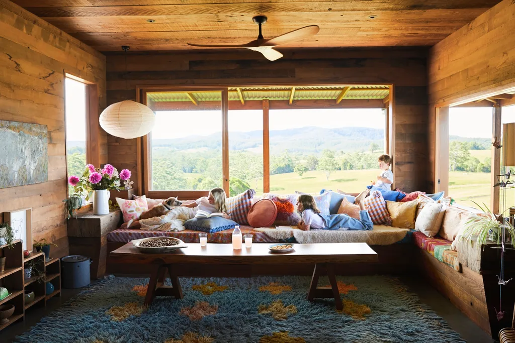 Family living area with colourful cushions and countryside views.