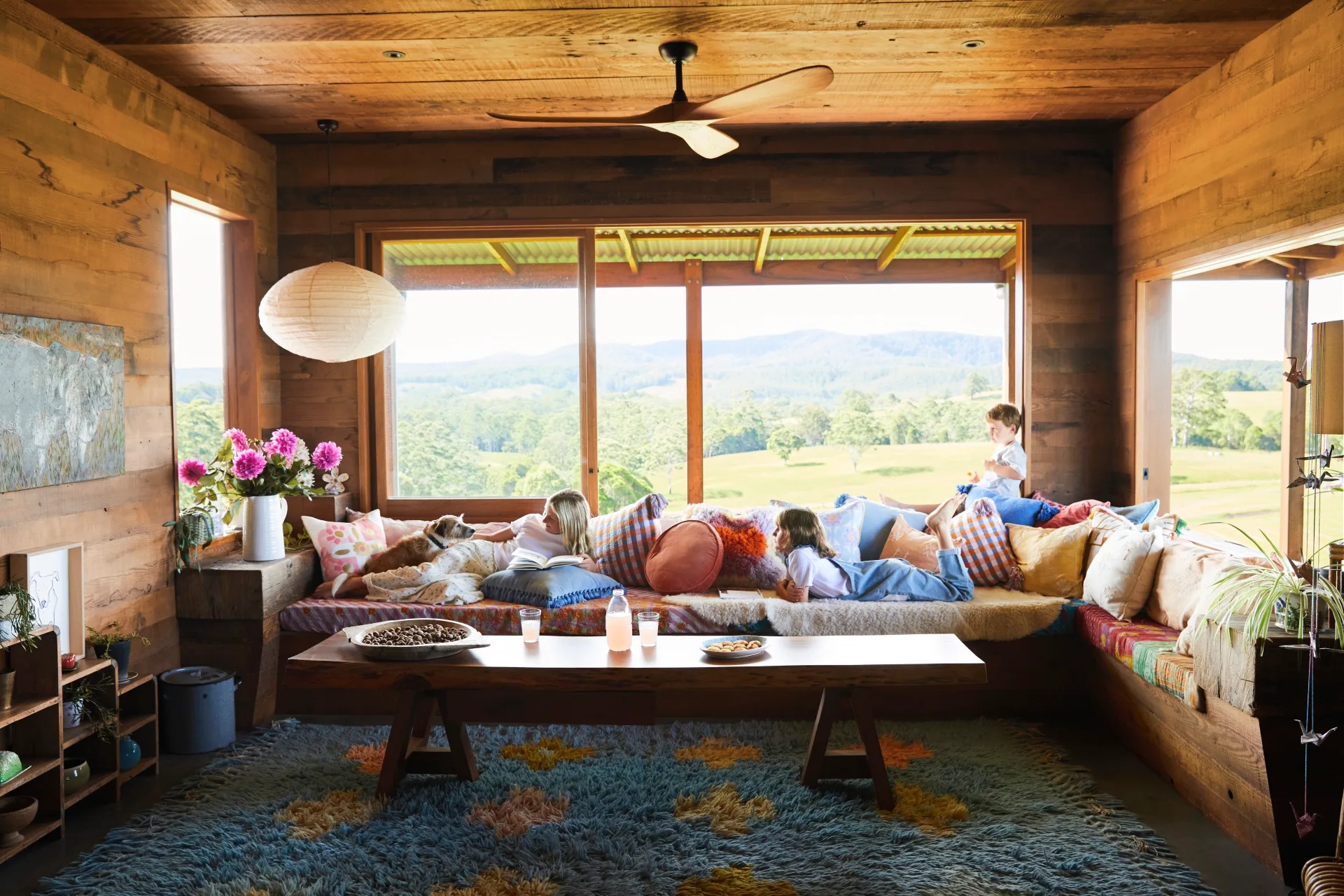 Family living area with colourful cushions and countryside views. 