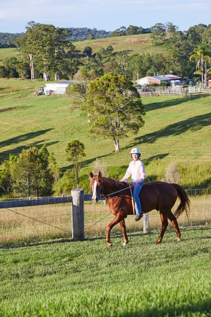 Riding a horse in the countryside.